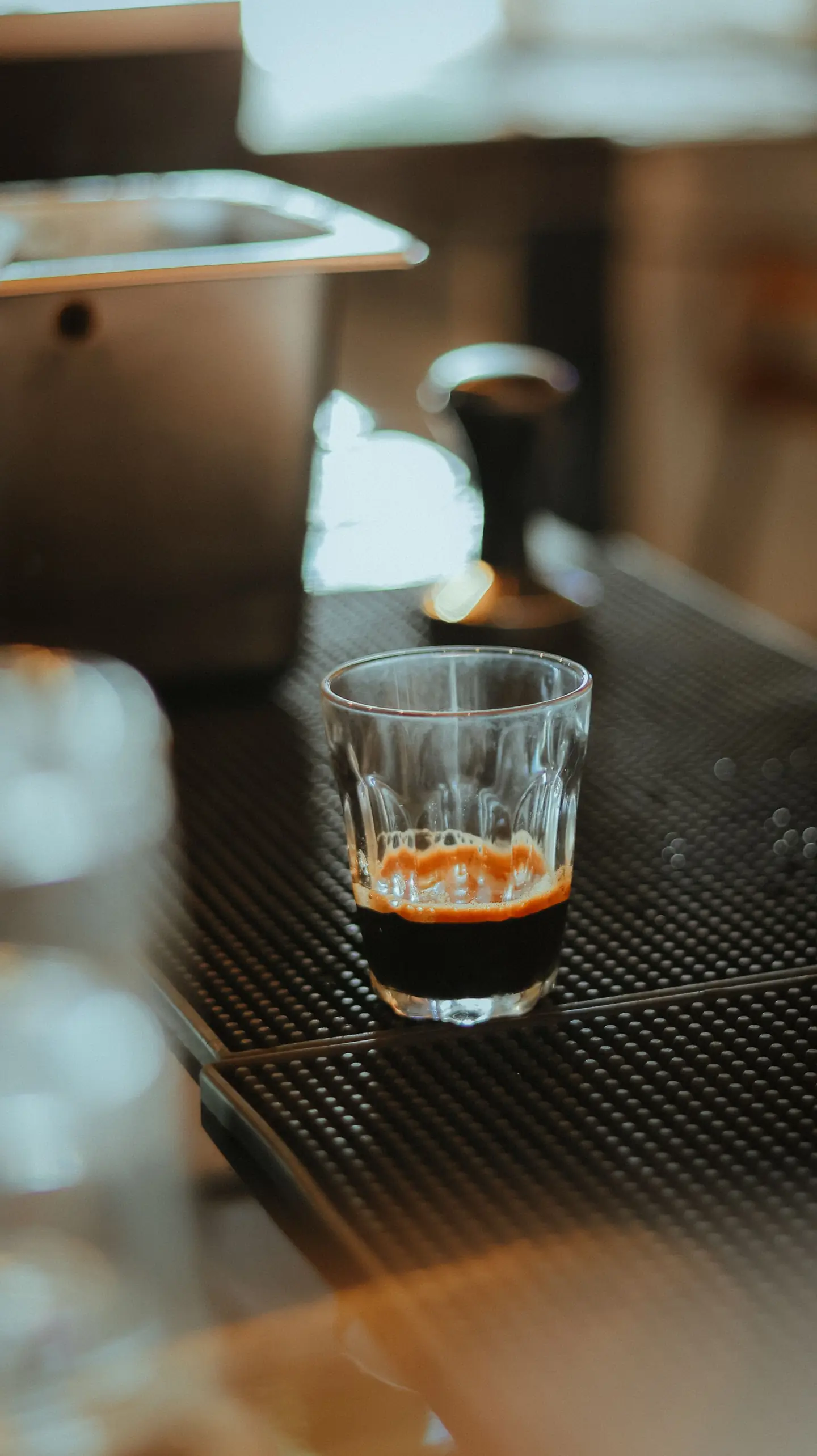 An espresso shot on a café counter in morning light