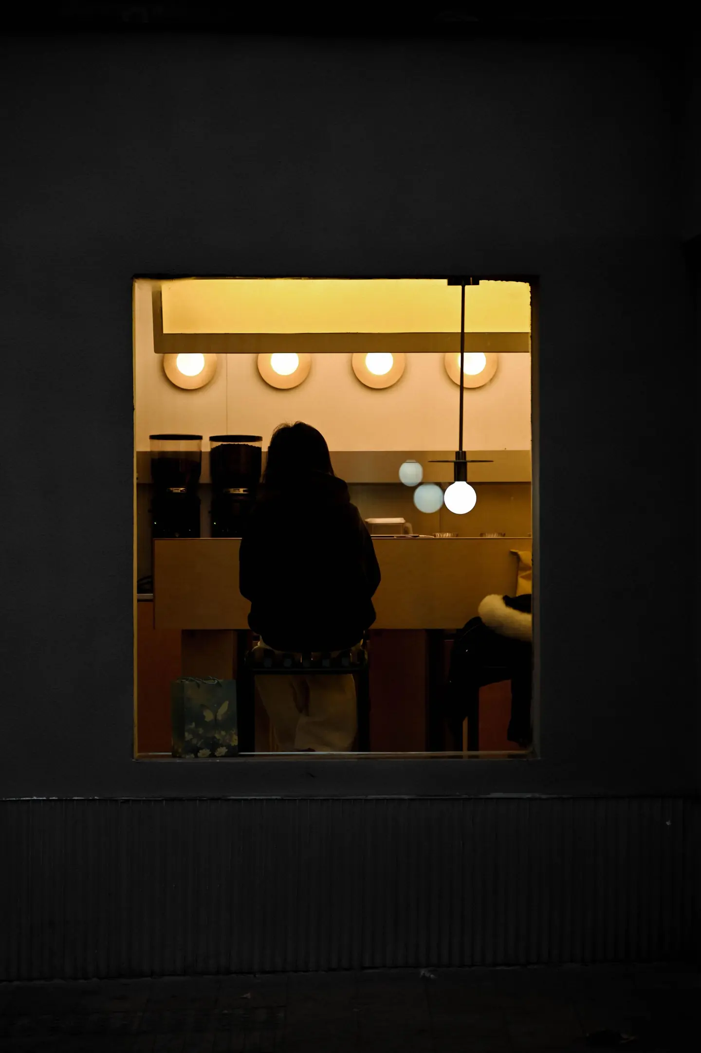 A lit café window at night