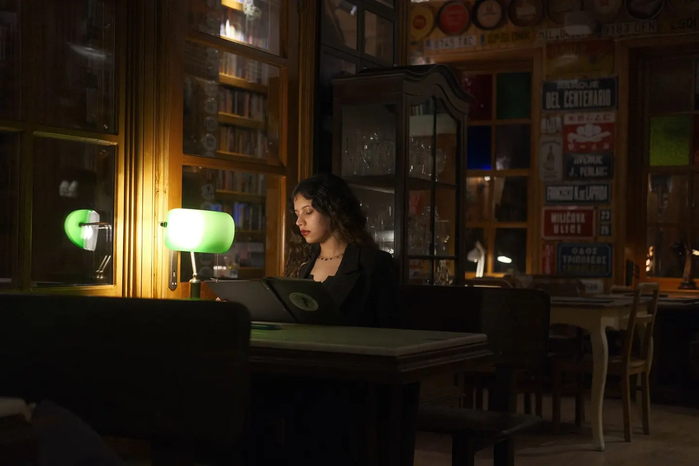 A student studying at a café table late at night